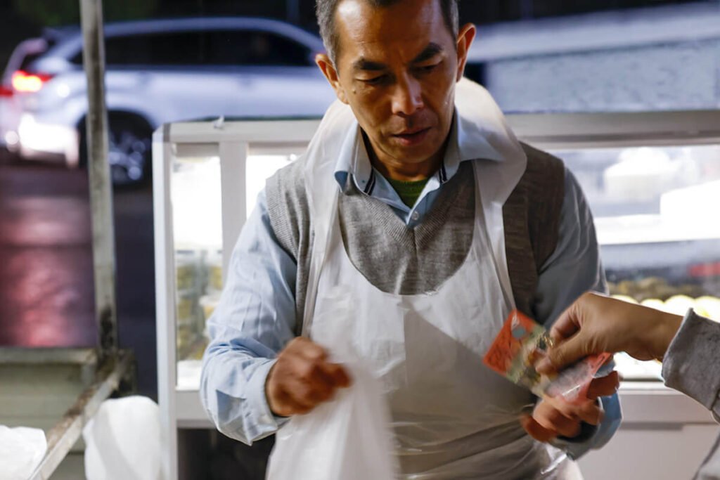 Community volunteer preparing food at Wat Buddharangsi Melbourne