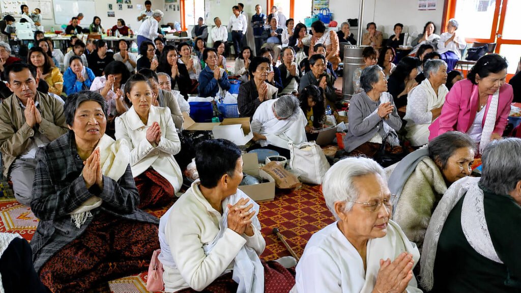 Khmer Buddhist community members praying together at Wat Buddharangsi Melbourne