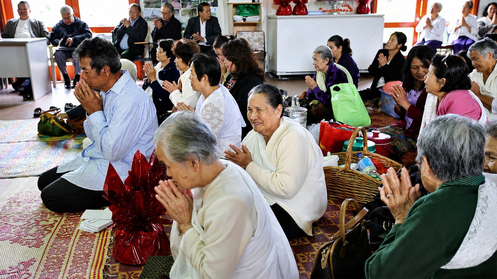 Khmer Buddhist community members praying together at Wat Buddharangsi Melbourne