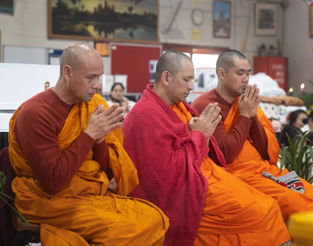 Buddhist monks praying at Wat Buddharangsi Melbourne