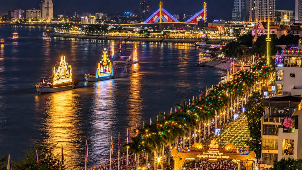 Illuminated boats on the river during Bon Om Touk Water Festival at night in Phnom Penh, Cambodia