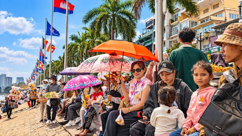 Crowds watching traditional boat races along the Phnom Penh riverside during Bon Om Touk Water Festival